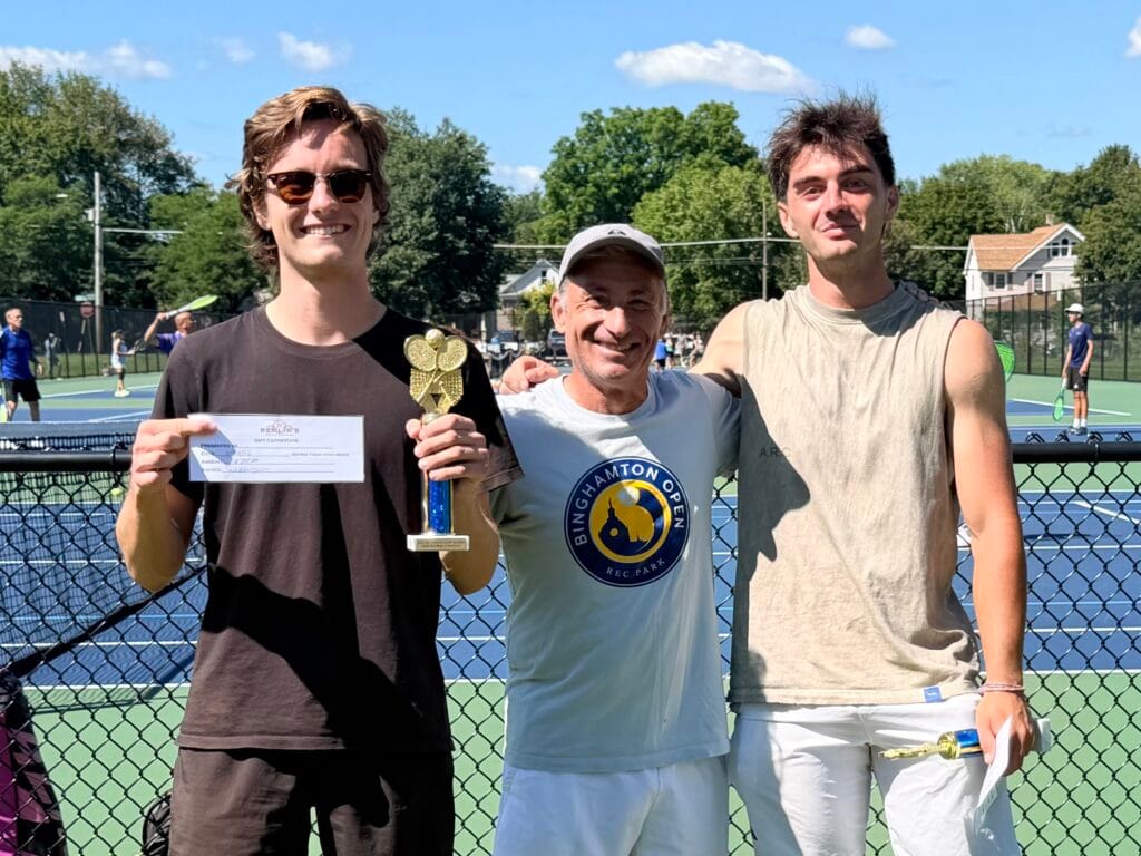 Doubles winners hold the trophy and prize envelope after the final