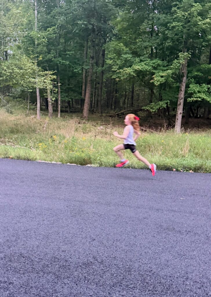 Young runner sprints to the finish line.