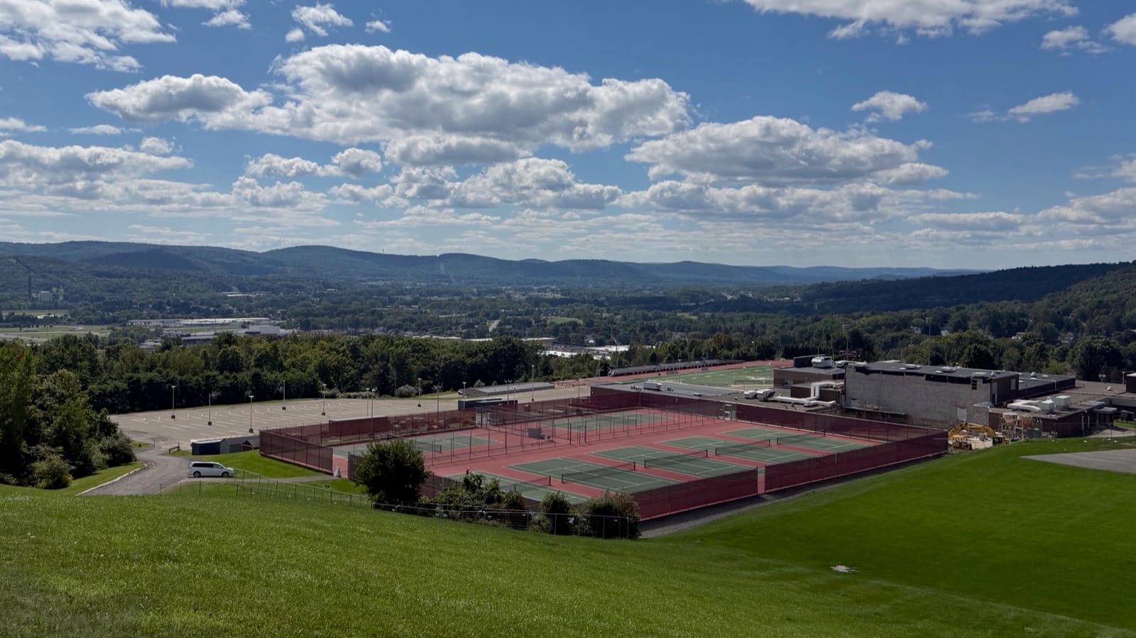 Johnson City High School tennis courts and playing fields from the hill above, with the Susquehanna valley behind.